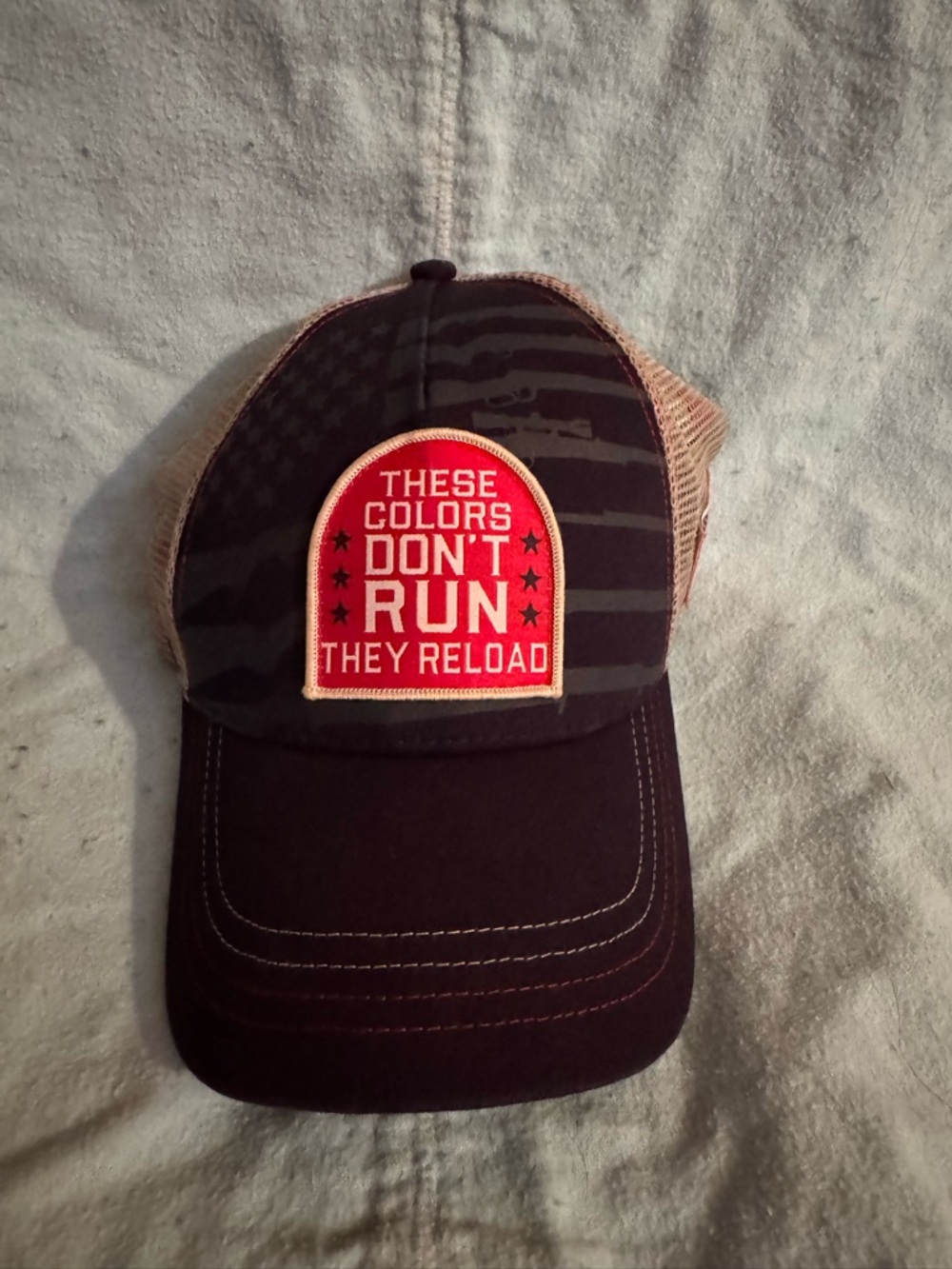 Patriotic Trucker Hat “These Colors Don’t Run They Reload” Mesh Snapback